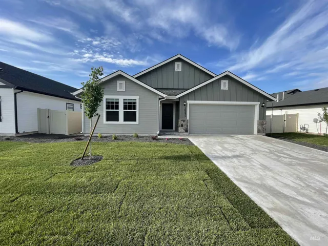 Single-story residence featuring a two-car garage, concrete driveway, and a partially sodded front yard