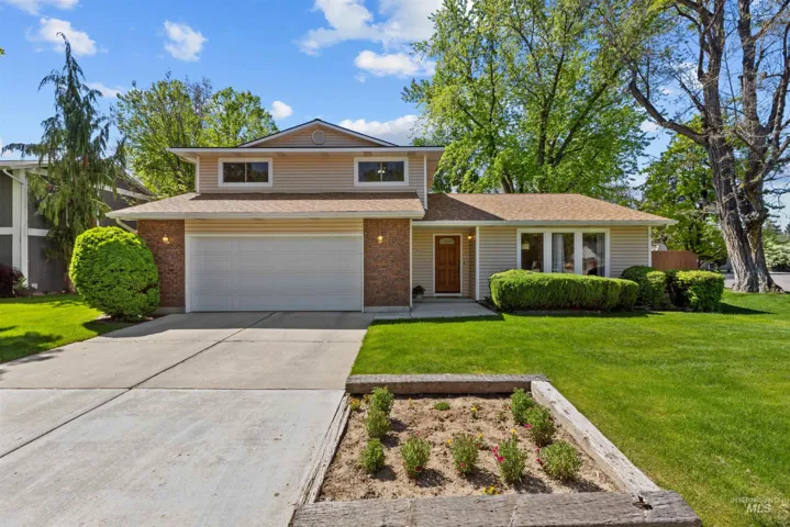 Split-level residence featuring brick and siding exterior