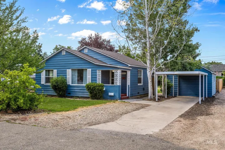 Blue siding exterior featuring white window shutters and a covered front porch