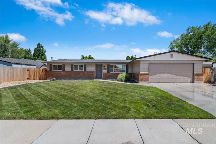 Ranch-style residence featuring a brick and siding exterior, a two-car garage, and a concrete driveway