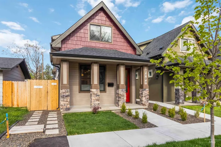 Craftsman-style facade with a prominent gable roofline and red shake siding