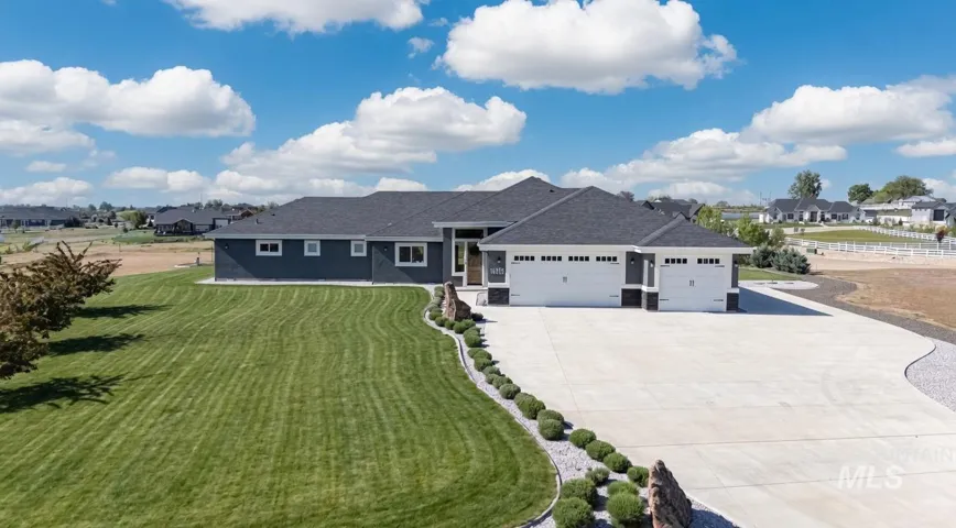 Contemporary single-story residence with a dark gray exterior and white trim