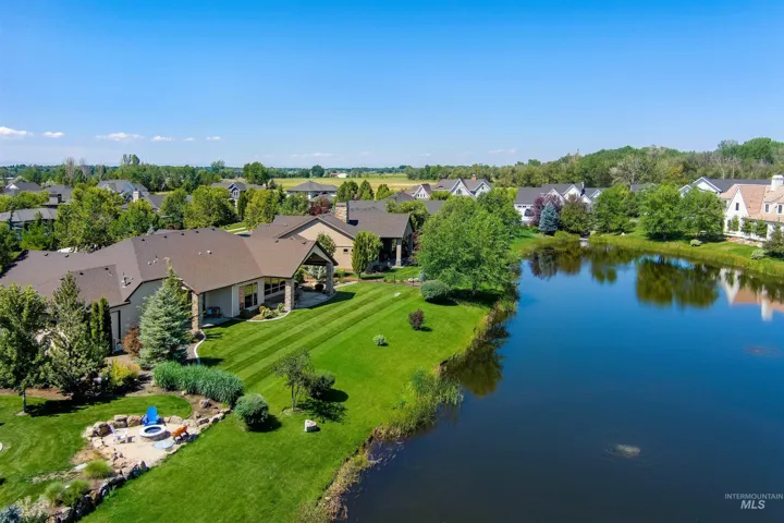 Aerial perspective of suburban area featuring a nearby body of water