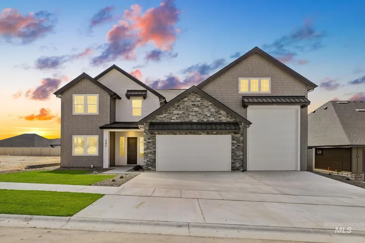 Two-story residence featuring a stone facade and shingle siding