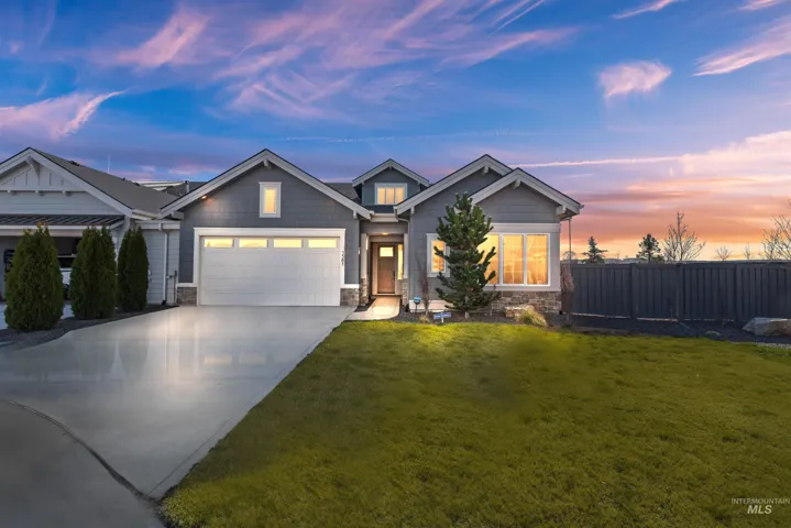 Craftsman house with stone siding, driveway, and an attached garage