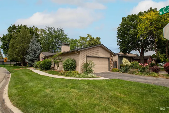 Contemporary residence featuring a two-car garage with a panel door