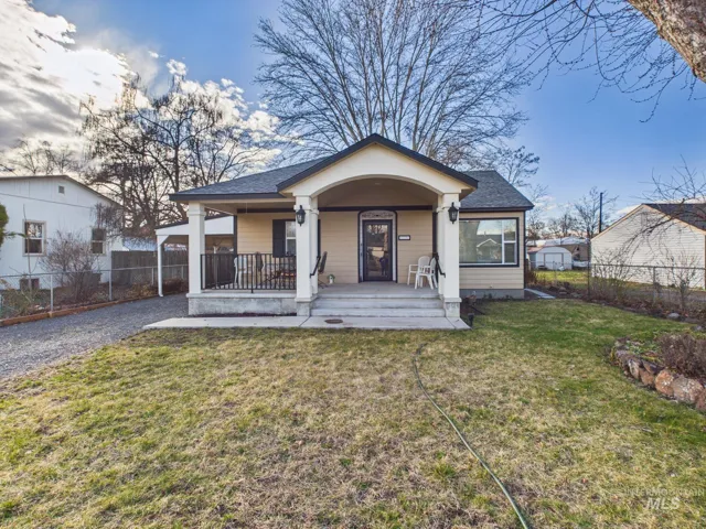 Bungalow featuring covered porch and a shingled roof