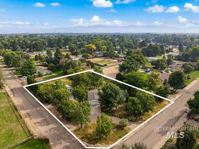 Expansive property with mature trees, established landscaping, and mountain scenery