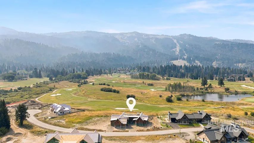 Mountain scenery, golf course proximity, surrounding forested hills, and a developed residential area