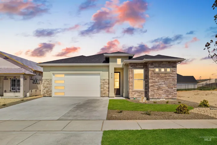Contemporary architecture featuring a stone and stucco exterior, an attached garage with translucent panels, and a concrete driveway