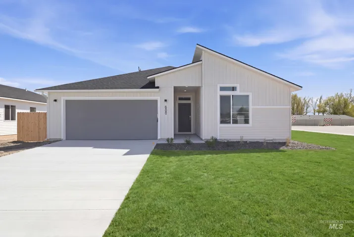 Modern single-story residence featuring a two-car garage, white vertical and horizontal siding, a dark asphalt shingle roof, a grey entry door, and a concrete driveway