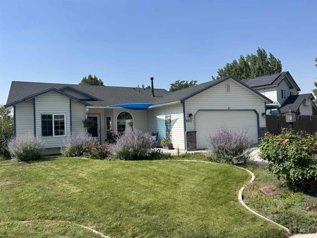 Single-story residence featuring light-colored siding with blue trim accents and a dark shingle roof