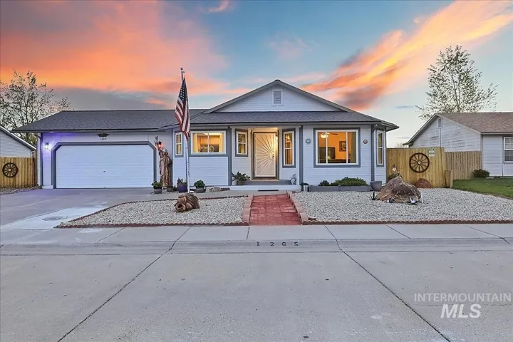 Bungalow featuring an attached garage, a porch, and driveway