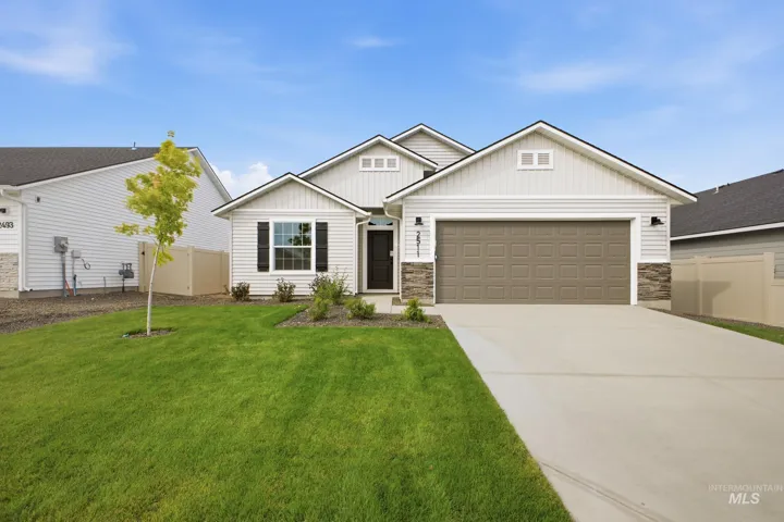 Single-level residence with siding exterior, stone accents, and an attached two-car garage