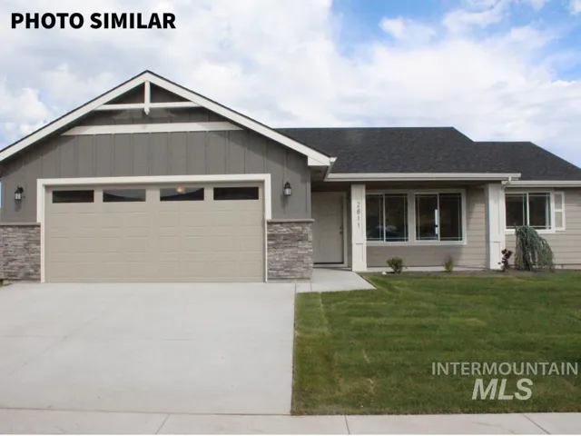 Contemporary single-story residence featuring a two-car garage with transom windows, a concrete driveway, and a covered entry