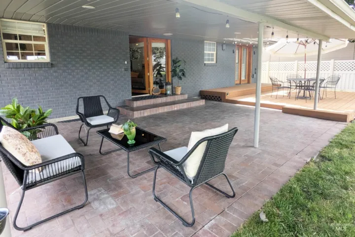 Covered patio featuring brick pavers and direct access to the interior through glass French doors