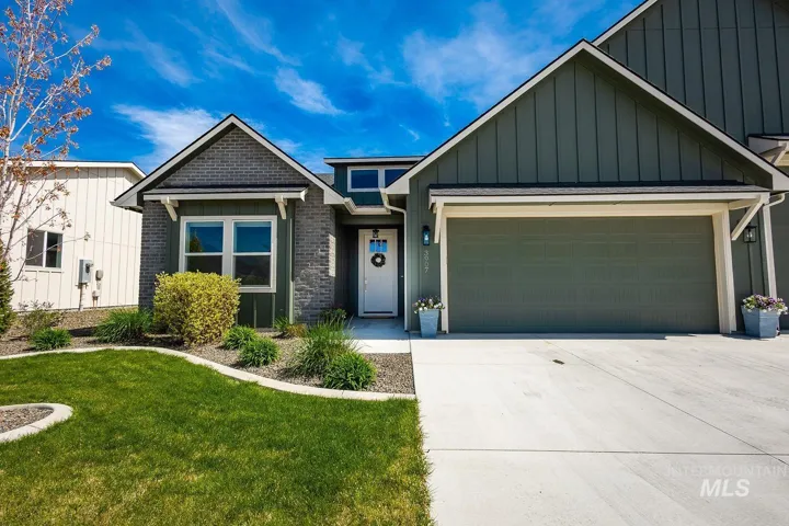 Modern exterior with board and batten siding, stone accents, and a two-car garage