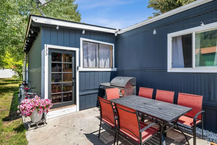 View of patio featuring grilling area and outdoor dining area