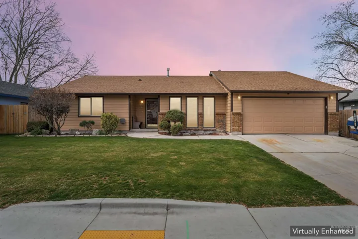 Ranch-style home with roof with shingles, a garage, concrete driveway, and brick siding