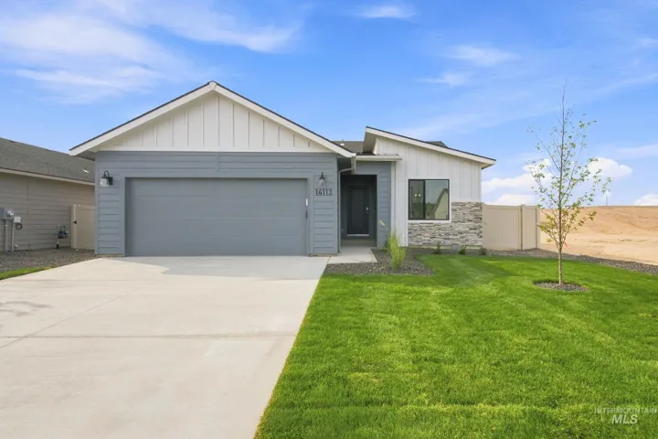 Contemporary exterior with mixed siding and stone accents, a concrete driveway, and an attached garage