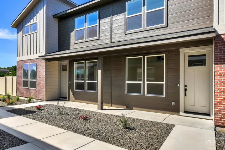 View of exterior entry with brick siding and board and batten siding