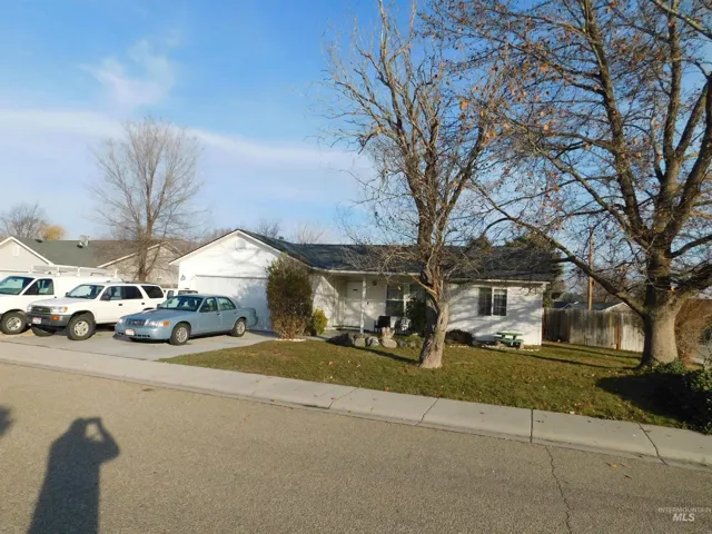 View of front of home featuring concrete driveway, a garage, and brick siding