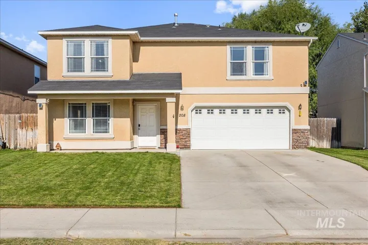Traditional home with stone siding, covered porch, stucco siding, and concrete driveway