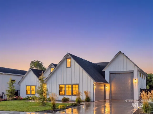 Modern farmhouse exterior with vertical white siding and dark gray trim