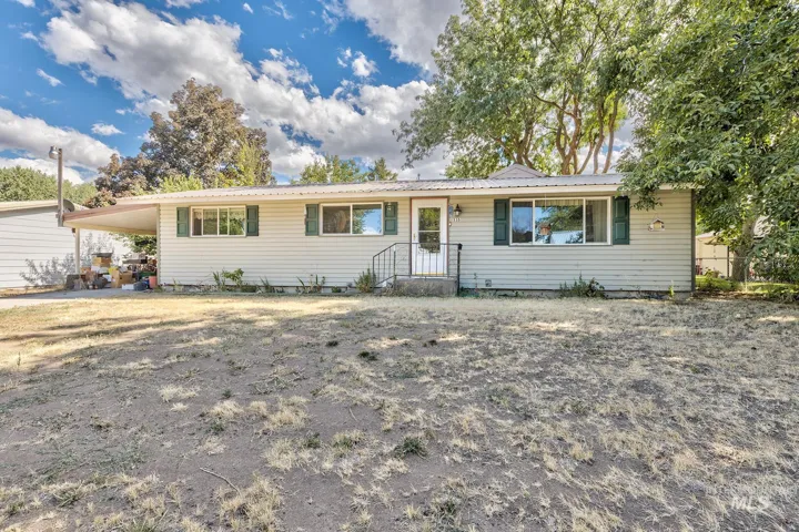 Single story home with an attached carport and a metal roof