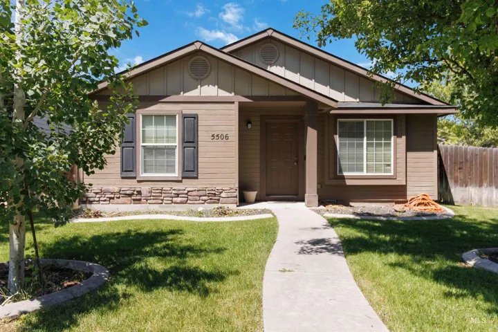 Single-story residence featuring a brown siding exterior with stone accent detailing