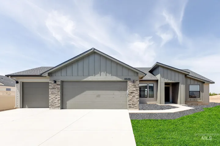 Modern exterior with board and batten siding, stone accents, and an attached three-car garage