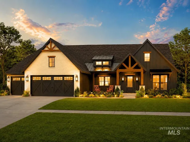 Exterior featuring a stucco and board-and-batten facade, prominent wood beam accents, a two-car garage with carriage-style doors, and a covered entry