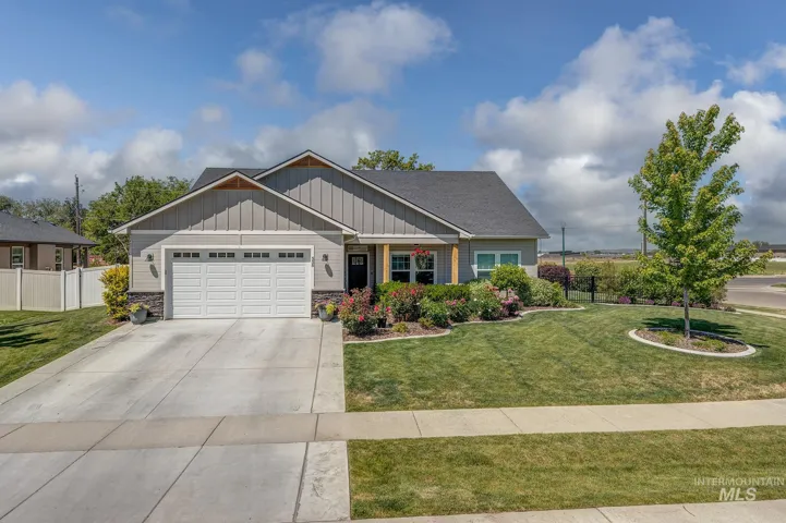 Contemporary single-story residence with a gray siding and dark roofline