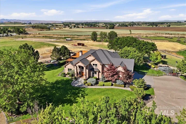 Expansive property featuring a brick exterior with multiple gables and a dark shingled roof